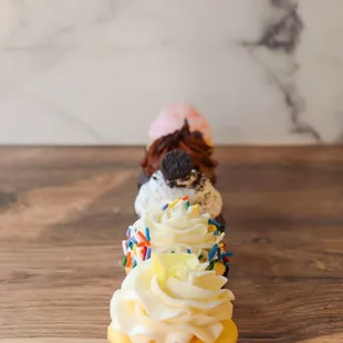 a single cupcake with white frosting and sprinkles