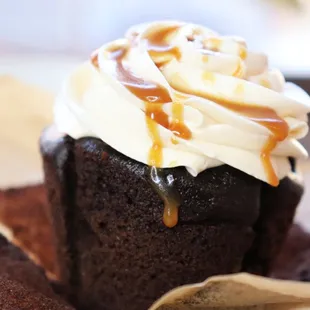a chocolate cupcake with caramel drizzle on top