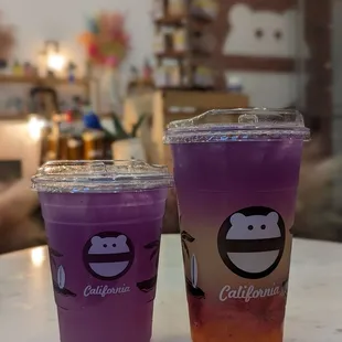 two cups of purple and orange drink