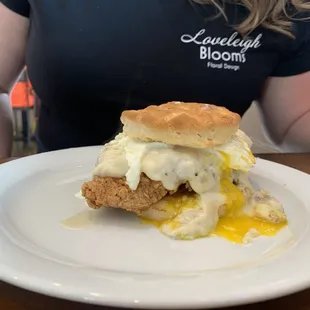 Chicken and biscuit with gravy and over easy egg