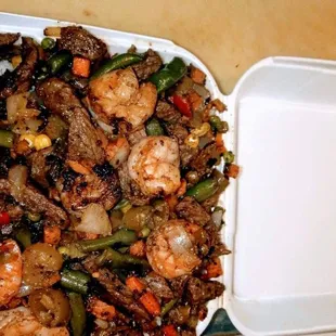 shrimp and vegetables in a styrofoam container