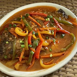 Escabeche (sweet and sour fish topped with different colors of peppers, carrots and green onions)