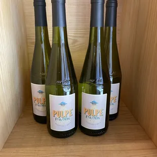 three bottles of wine on a shelf