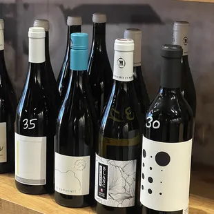 a row of wine bottles on a shelf