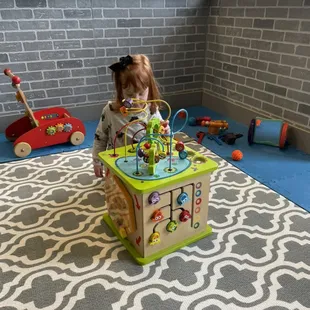 a little girl playing with a toy