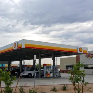 a gas station with a truck parked in front of it
