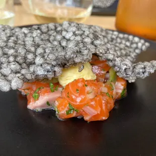 Tina tartare with tapioca crack infused with squid ink