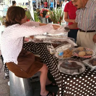 a woman handing a pie to a man