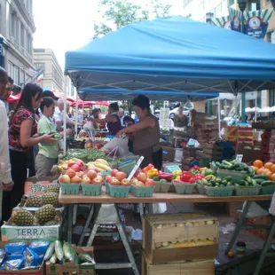 people shopping at a farmers market