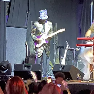 a man on stage with a guitar