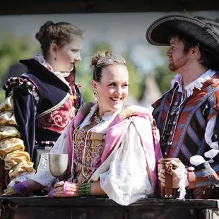 A man and two women riding on carriage!
