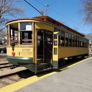 Passengers leave from the rear door.  You can see the trolly pole that is connected to the electric wire.