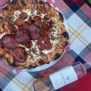Meat, lovers pizza, and a bottle of Everly Farms rosé