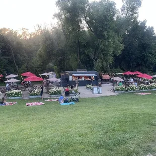 Their outdoor setup with tables, picnic blankets, live music!