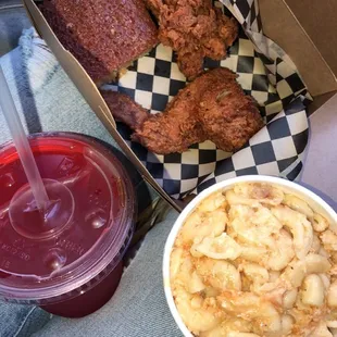 a basket of food and a cup of drink