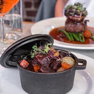 a plate of food and a glass of wine