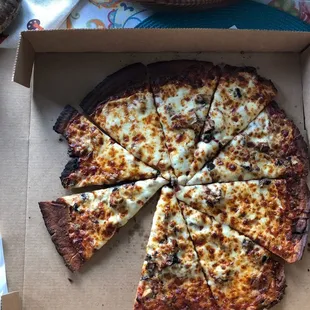 Burnt incomplete pizza