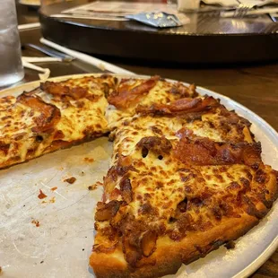 a half eaten pizza on a plate