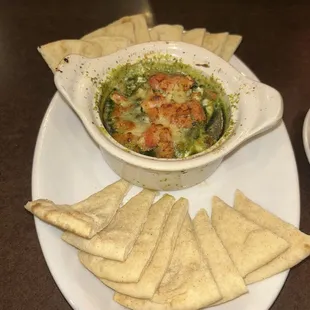 Pesto and cream cheese dip with pita chips