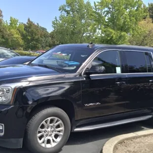 Black GMC Yukon XL SUV available. Seats 7 passengers.