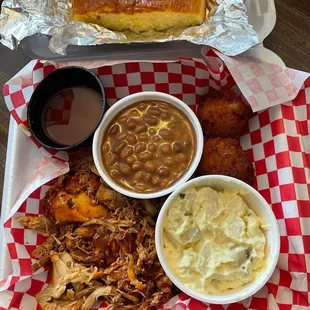 Brisket with sides of baked beans and potato salad