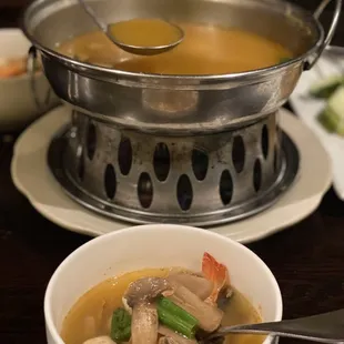 a bowl of soup and a pot of soup