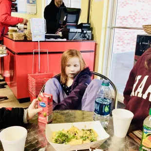a girl and a girl sitting at a table