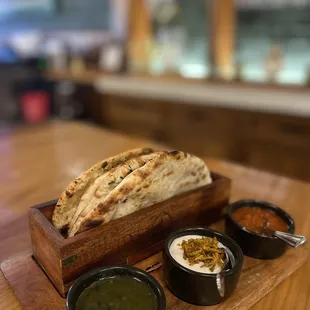 a flat bread and bowls of dips