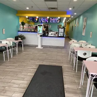 the interior of a restaurant with tables and chairs