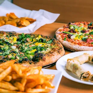 three different pizzas and french fries