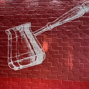 a spatula drawn on a brick wall