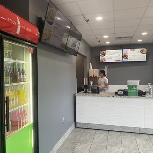 Inside of the restaurant. Where you order, menu on tvs.