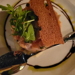 a plate with a sandwich and a spoon