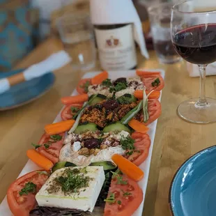 a plate of food and a glass of wine