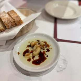 a bowl of soup and bread on a table