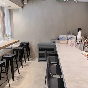 a kitchen with a counter and chairs