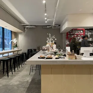 a kitchen and dining area with tables and stools