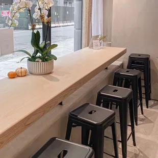 a row of stools in front of a counter
