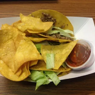 Three beef tacos with some chips