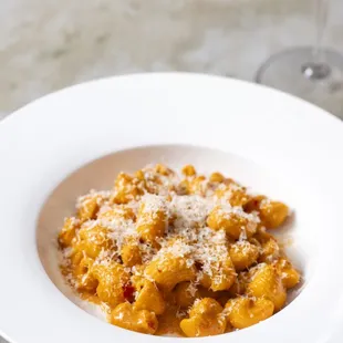 a plate of pasta and a glass of wine