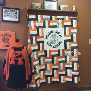 a quilt hanging on a wall