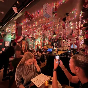 a woman taking a picture of herself in a restaurant