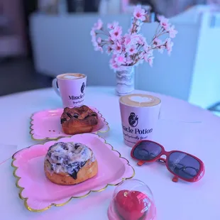 a cup of coffee, donuts, and sunglasses on a table