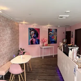 a salon with pink walls and chairs