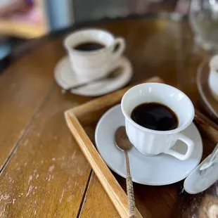 a tray of coffee and doughnuts