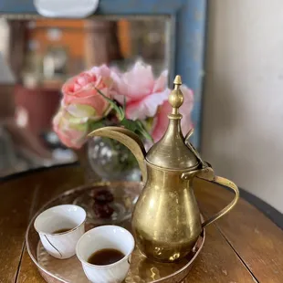 a teapot and two cups on a tray
