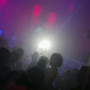 a crowd of people dancing at a nightclub