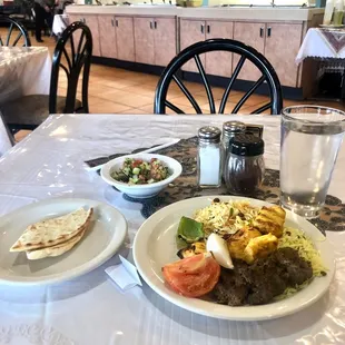 a plate of food and a glass of water