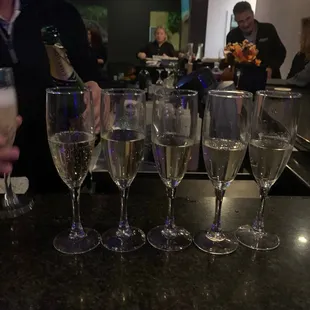 a man pouring a glass of champagne