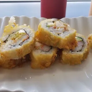 a plate of sushi rolls